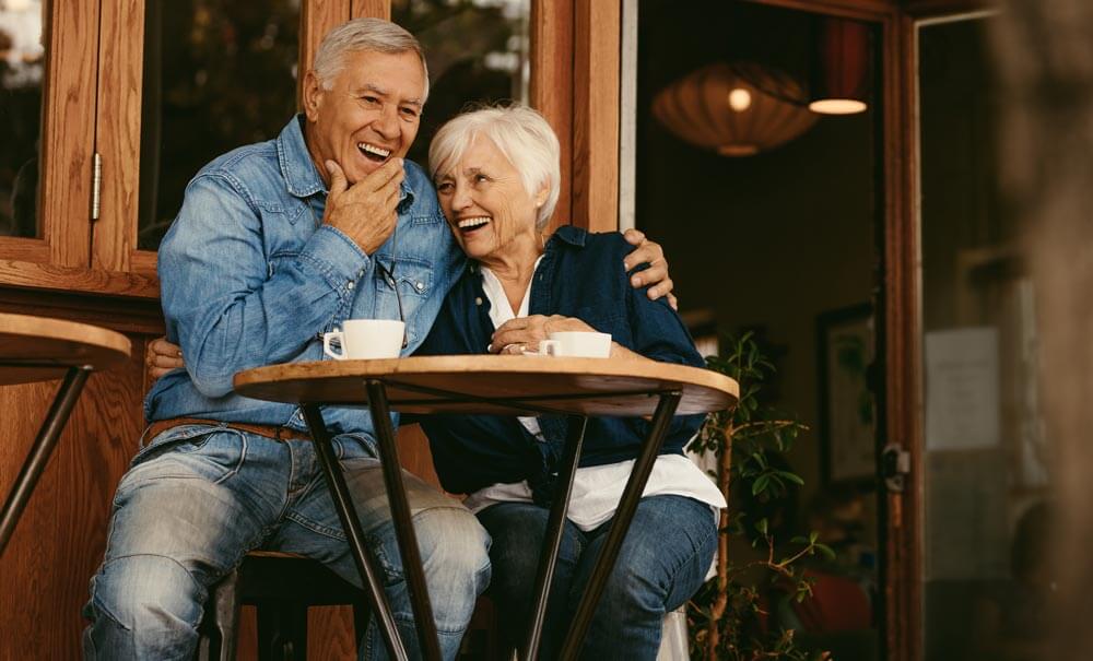 Laughing Older Couple at Outdoor Cafe
