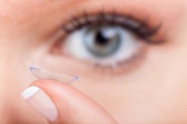 Contact Lens on finger in front of an eye